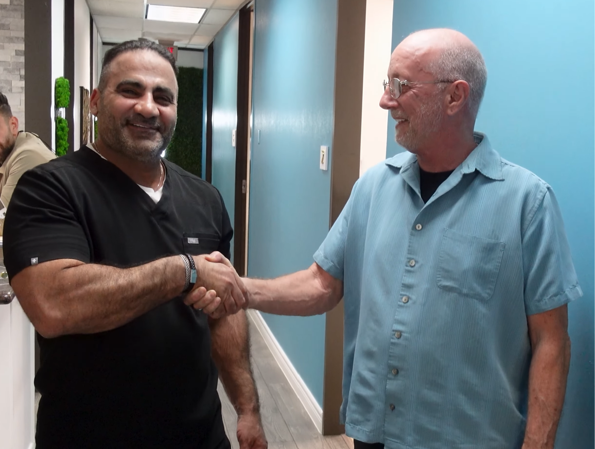 Dr. Firas greeting a patient at the clinic